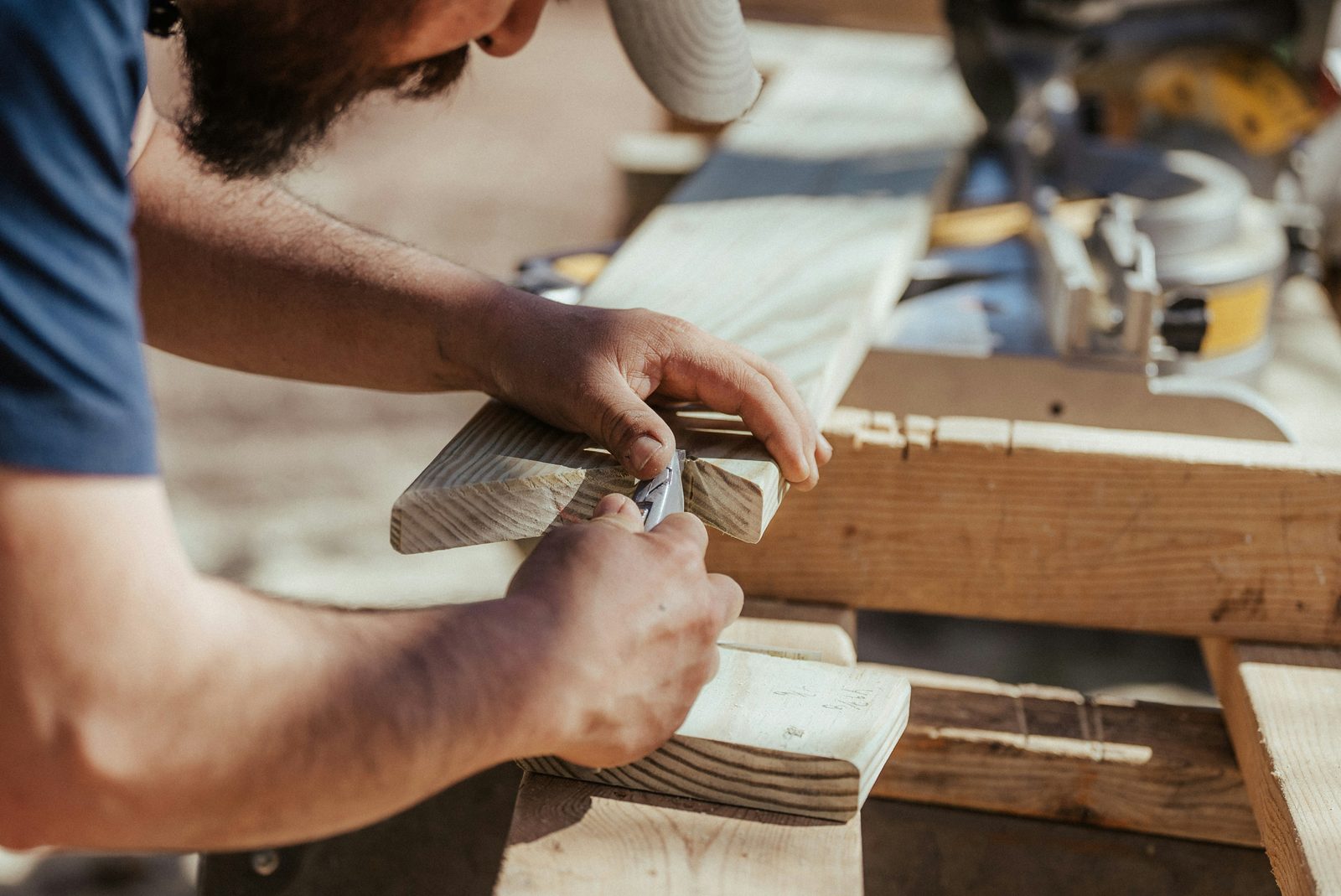 Carpenter measuring oak in a North London workshop